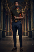 Wear this shirt like the designer king you truly are. Show the world you strength, purpose, faith, hope, and ambition. 
A short-sleeve polo shirt with a black base featuring a fiery orange and red flame pattern across the lower front, a gold crown and ornate gold baroque design on the chest and right sleeve, and a matching flame motif on the left chest and collar area, shown on a plain white background.